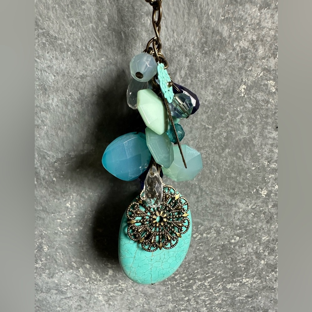 Long Gold Tone Necklace Embellished with colorful Stones & Metal design’s